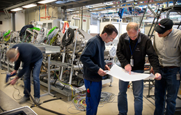 Engineers and technicians from Ampulse, NREL, and Roth &amp; Rau: go over plans for installing parts in the pilot production line for making solar cells via a chemical deposition process. Credit: Dennis Schroeder